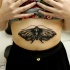 Black ink engraving style belly tattoo of small butterfly