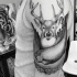 Black ink engraving style shoulder tattoo of deer with fish