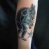 Black ink forearm tattoo of funny werewolf and small star