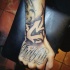 Black ink graffiti style wrist tattoo of cool ornament