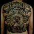 Black ink large whole back tattoo of ancient stone statue