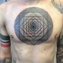 Black ink linework style chest tattoo of cool looking ornment
