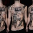 Black ink photoshop style chest and belly tattoo of lettering with camera and gun