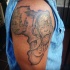 Black ink shoulder tattoo of Africa continent with tribal people