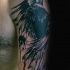 Black ink shoulder tattoo of dark crow