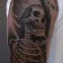 Black ink shoulder tattoo of Egypt skeleton with lettering