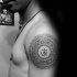 Black ink shoulder tattoo of Hinduism symbol
