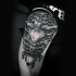 Black ink shoulder tattoo of human bones