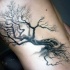 Black ink side tattoo of lonely tree with broken branch