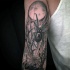 Black ink sleeve tattoo of dark spider and web
