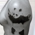 Black ink strange looking shoulder tattoo of panda bear with pistols