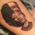 Black ink thigh tattoo of half modern half Egypt woman