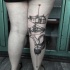 Black ink thigh tattoo of little house with flowers and little baby