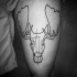 Black ink tribal thigh tattoo of elk head