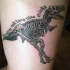 Black ink very detailed biceps tattoo of dinosaur skeleton with lettering