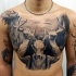 Black ink very detailed chest tattoo of mystical man with deer skull