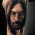 Black ink very detailed portrait style tattoo of Lennon face