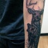 Black ink watercolor style medium size forearm tattoo of roaring bear and deer