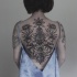 Black ink whole back tattoo of various flowers