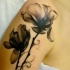 Black poppies tattoo on shoulder