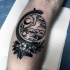 Blackwork style amazing looking leg tattoo of globe with flowers