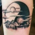 Blackwork style big Yin Yang symbol tattoo on forearm stylized with mountains