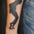 Blackwork style forearm tattoo of Michael Jackson silhouette