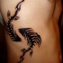 Blackwork style interesting looking side tattoo of fish skeletons