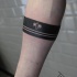 Blackwork style simple arm tattoo of lines stylized with small bee