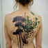 Black and green geometric tree tattoo on back