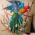 Breathtaking realism style very detailed back tattoo of parrot with flowers
