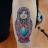 Bright colorful matryoshka with gems tattoo on forearm by Javi Wolf