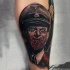 Brilliant real photo style colored Nazi zombie portrait tattoo on forearm
