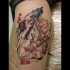 Carelessly painted colored romantic Asian kissing couple tattoo on leg