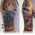 Cartoon style colored shoulder tattoo of pirate ship with Peter Pan