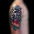 Cartoon style colored shoulder tattoo of raccoon with pie slice