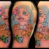 Cartoon style colored shoulder tattoo of funny little baby with cubes and toys