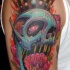 Cartoon style colored shoulder tattoo of fantasy skull with crown