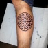 Celtic style black and white leg tattoo fo cool looking knot