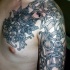 Celtic style black ink shoulder and chest tattoo of various ornaments