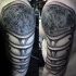 Celtic style black ink shoulder tattoo of medieval armor