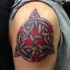 Celtic style shoulder tattoo of large symbol