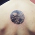 Circle shaped beautiful looking back tattoo stylized with ornaments