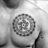 Circle shaped black ink chest tattoo of Hinduism ornament