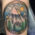 Circle shaped illustrative style colored leg tattoo of mountains view and lettering