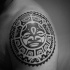 Circle shaped medium size black ink shoulder tattoo of Polynesian ornaments