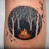 Circle shaped small dark forest tattoo with fire