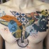 Colored abstract style chest tattoo of various symbols with lettering