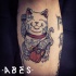 Colored amazing looking leg tattoo of funny maneki neko japanese lucky cat with broken skate