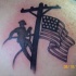 Colored American native scapular tattoo of lineman with flag